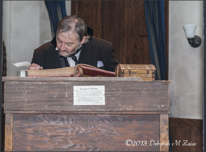 Ebenezer Scrooge working at his Office